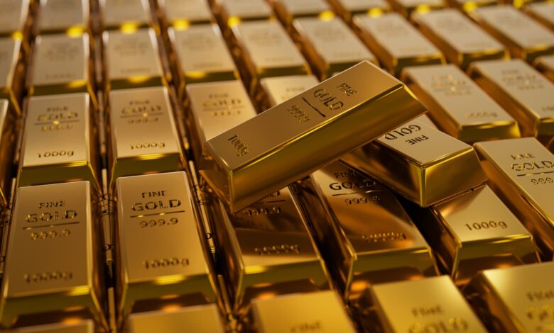 107375377 1708403102580 gettyimages 1324553383 3dillustrationoftwogoldbarslayingonregularstackedlaye